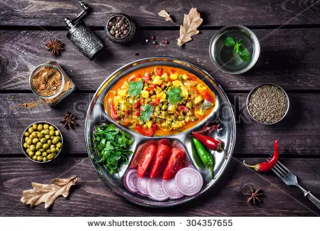stock-photo-indian-mutter-paneer-dish-with-spices-on-the-wooden-background-304357655
